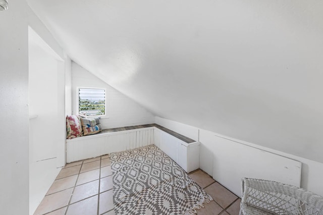 bonus room featuring lofted ceiling and light tile patterned floors