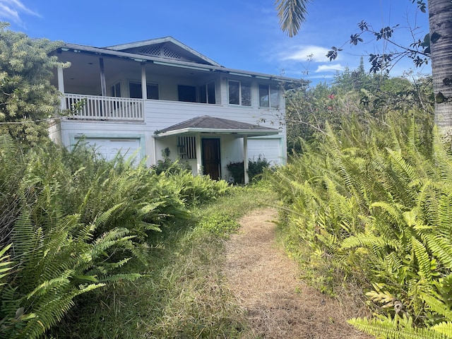 exterior space with a garage and a balcony