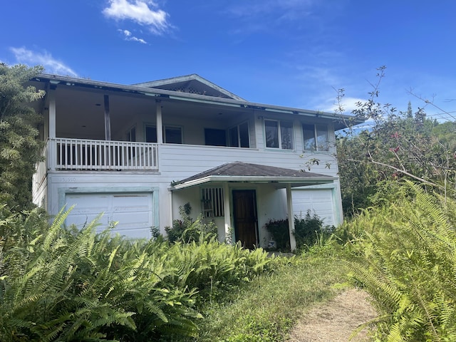 view of front of property with a garage and a balcony