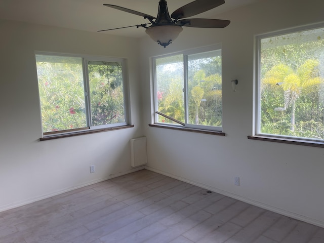 empty room with ceiling fan and light wood-type flooring