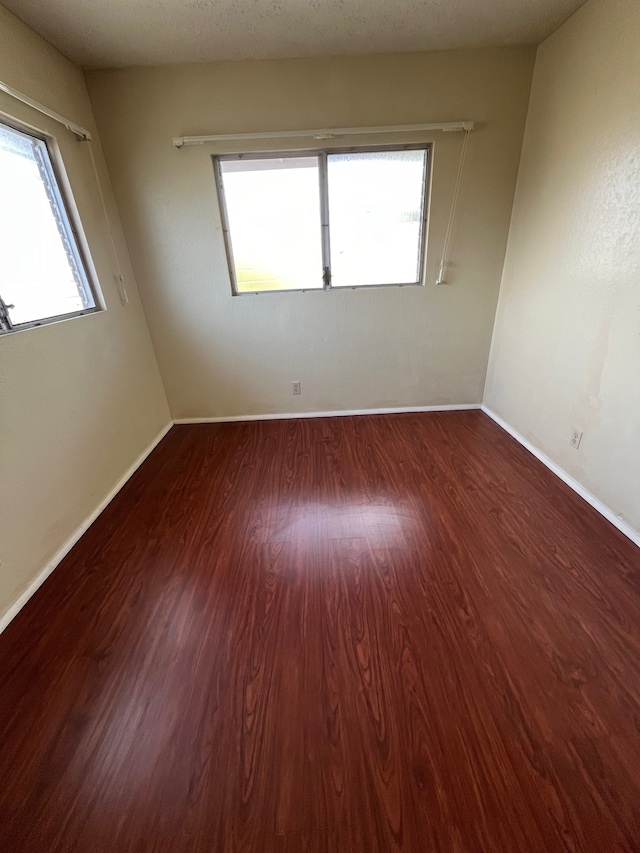 spare room featuring dark hardwood / wood-style flooring