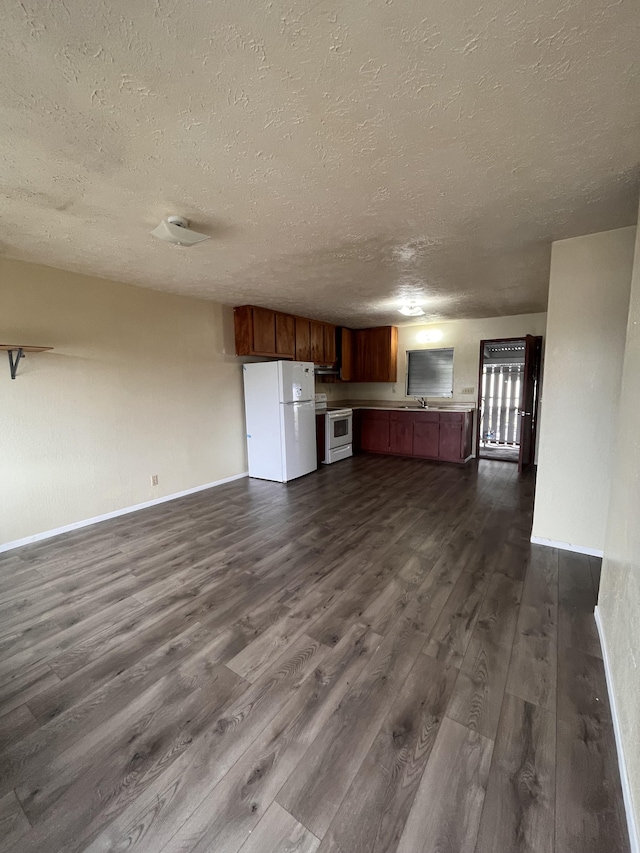 unfurnished living room featuring dark hardwood / wood-style floors and a textured ceiling