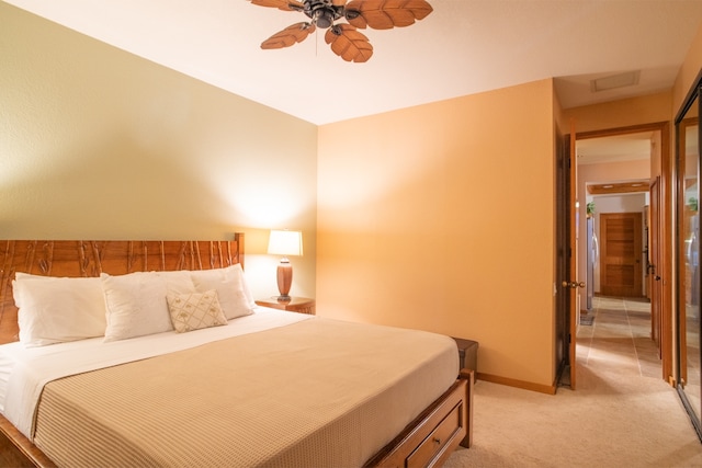 bedroom with ceiling fan and light carpet