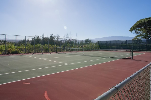 view of tennis court featuring a mountain view and basketball hoop