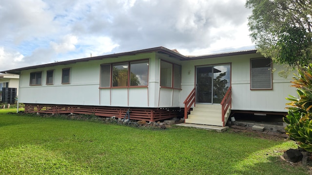 view of front facade with entry steps and a front yard