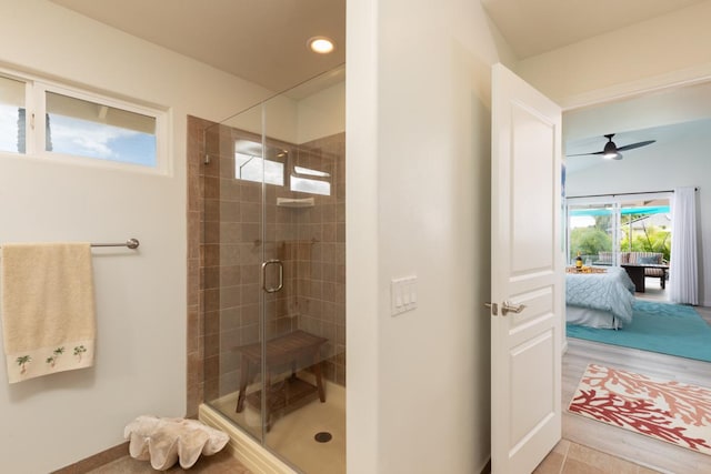 ensuite bathroom with a stall shower, connected bathroom, recessed lighting, and ceiling fan