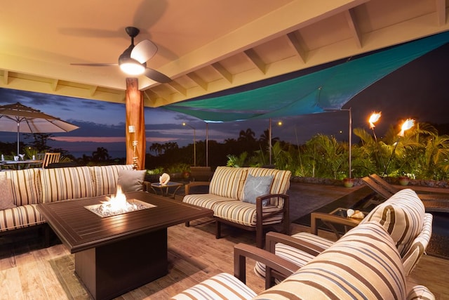 view of patio / terrace with a deck and an outdoor living space with a fire pit