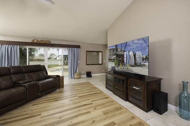 living room featuring high vaulted ceiling and light hardwood / wood-style flooring