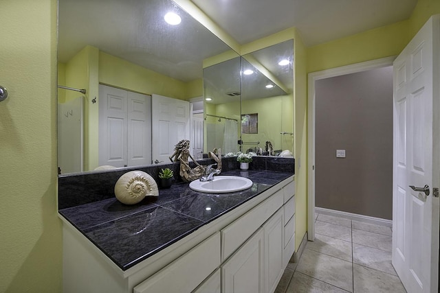 bathroom with vanity, tile patterned floors, and walk in shower