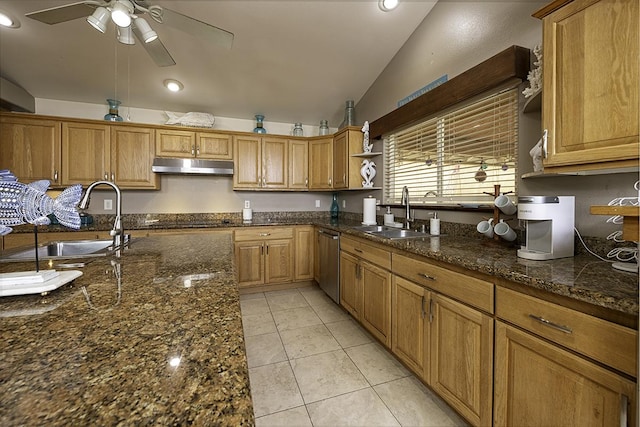 kitchen with lofted ceiling, sink, dark stone countertops, and dishwasher