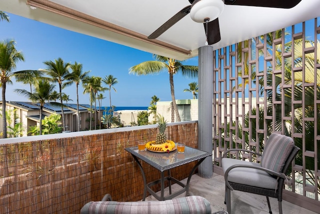 balcony with a water view and ceiling fan