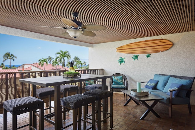 balcony with a ceiling fan, outdoor dining area, and an outdoor hangout area