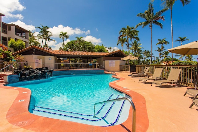 pool with fence and a patio