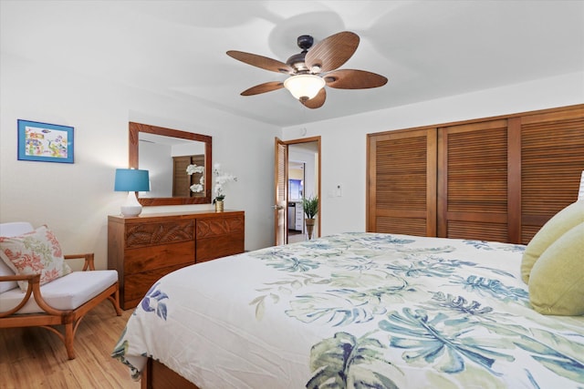 bedroom featuring a ceiling fan, a closet, and wood finished floors