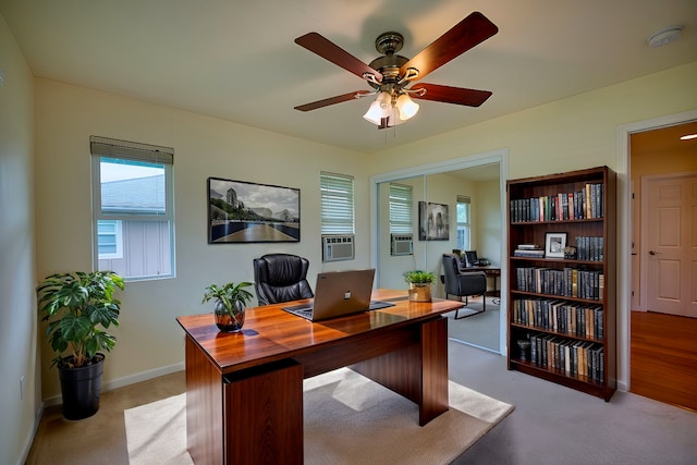 carpeted office space featuring cooling unit and ceiling fan