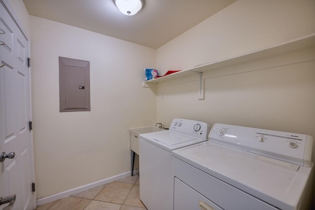 laundry area with separate washer and dryer, light tile patterned floors, and electric panel