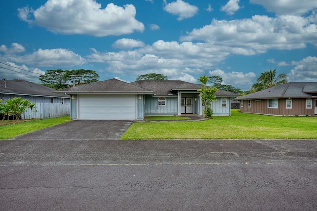 ranch-style home with a garage and a front lawn