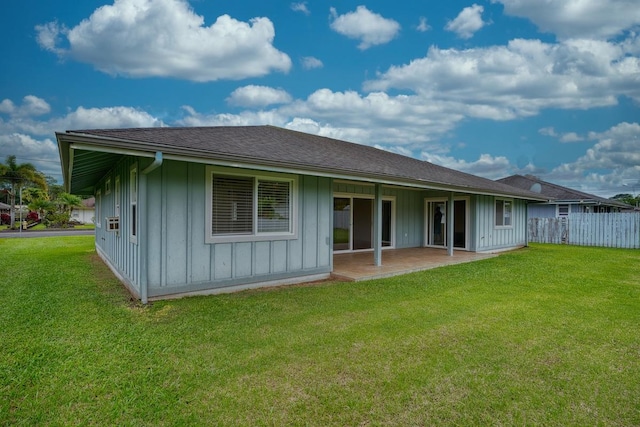 back of house featuring a lawn and a patio area