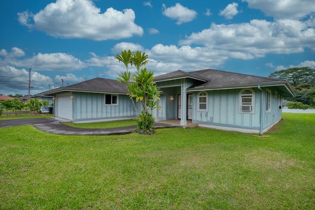 view of front of house with a garage and a front lawn