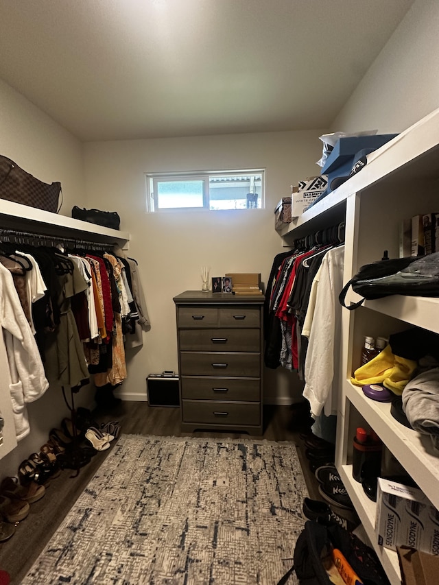 walk in closet with dark hardwood / wood-style flooring