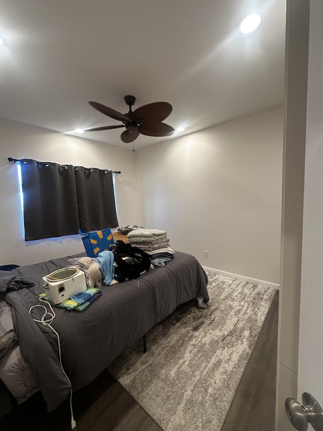 bedroom with dark wood-type flooring and ceiling fan