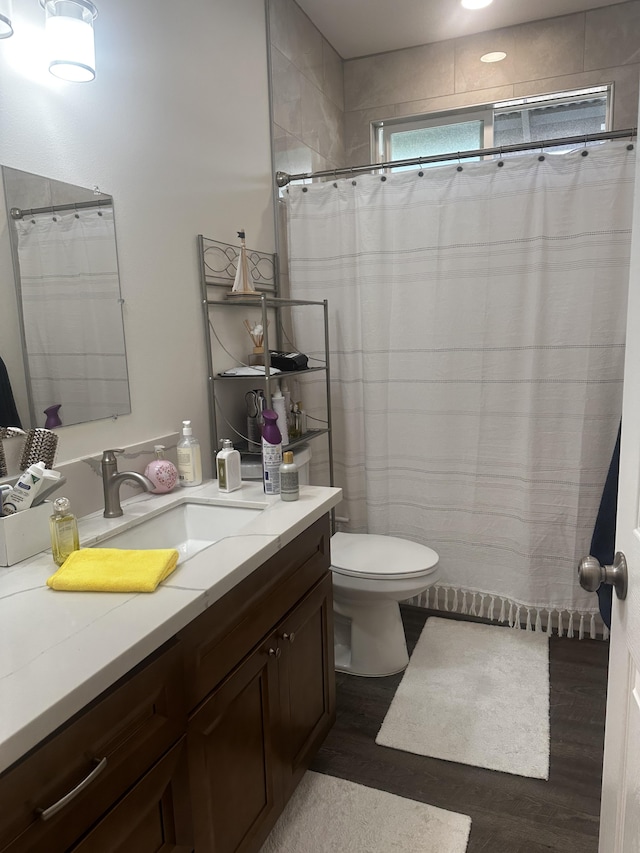 bathroom featuring vanity, hardwood / wood-style floors, and toilet