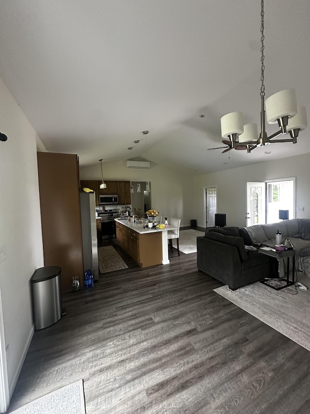 interior space featuring tasteful backsplash, hanging light fixtures, dark hardwood / wood-style floors, a kitchen island, and stainless steel appliances