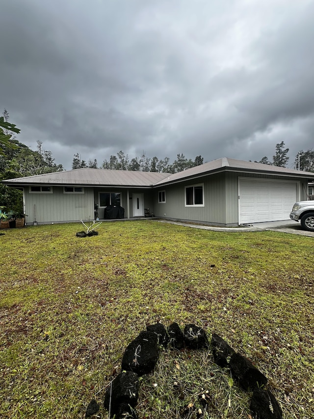 single story home featuring a garage and a front yard