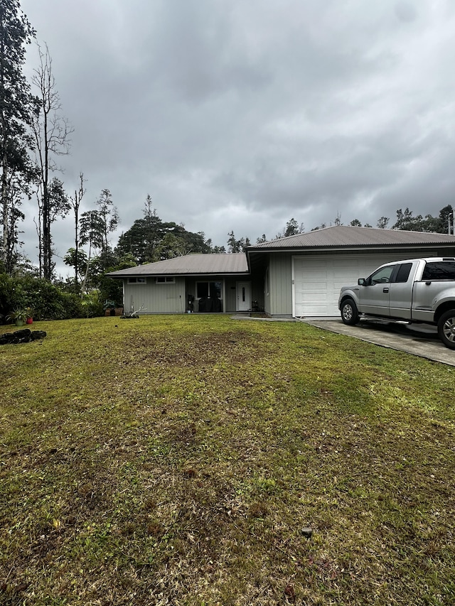 view of front of property featuring a garage and a front lawn