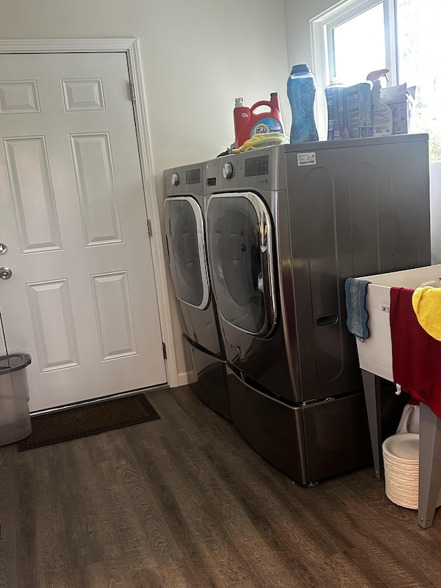 laundry area featuring dark hardwood / wood-style flooring and washing machine and dryer