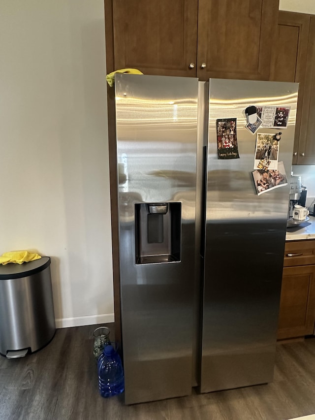 kitchen featuring dark wood-type flooring and stainless steel fridge