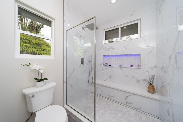 bathroom with toilet and a tile shower