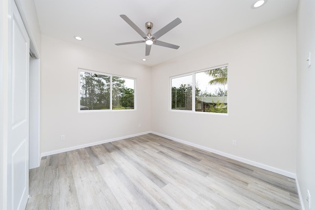 empty room with light hardwood / wood-style floors and ceiling fan