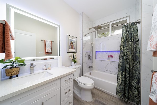 full bathroom with shower / bath combo with shower curtain, hardwood / wood-style floors, toilet, and vanity