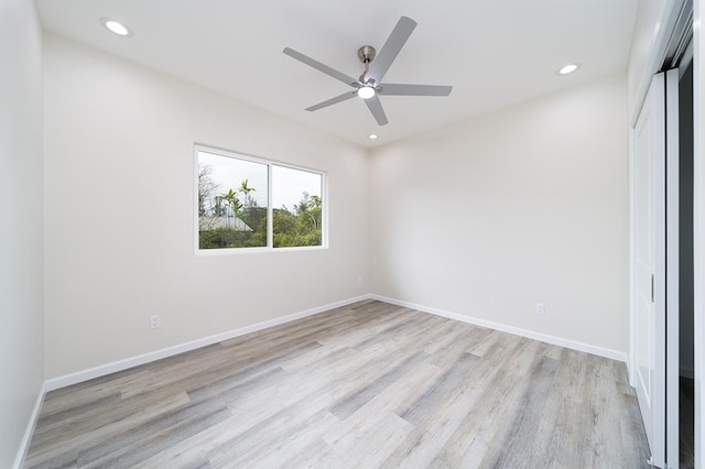 unfurnished bedroom with ceiling fan, light hardwood / wood-style flooring, and a closet