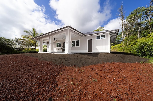 back of property featuring ceiling fan and a patio area