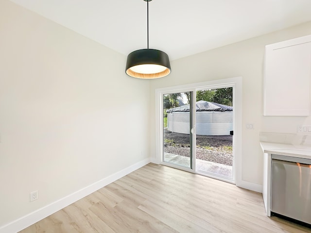 unfurnished dining area with light wood-type flooring