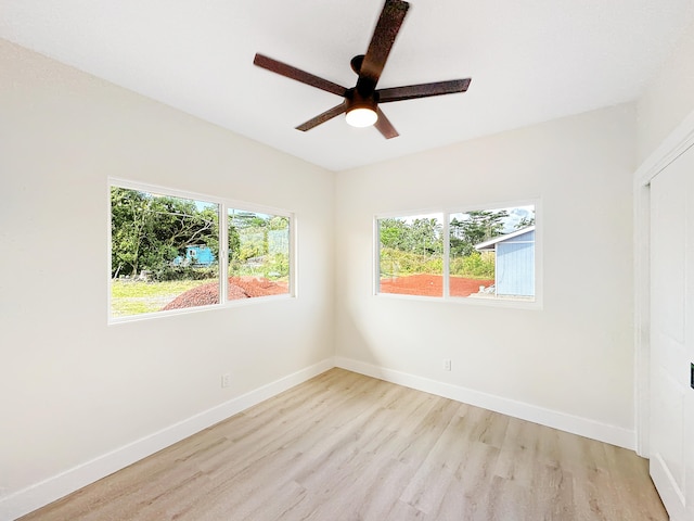 unfurnished room with ceiling fan and light wood-type flooring