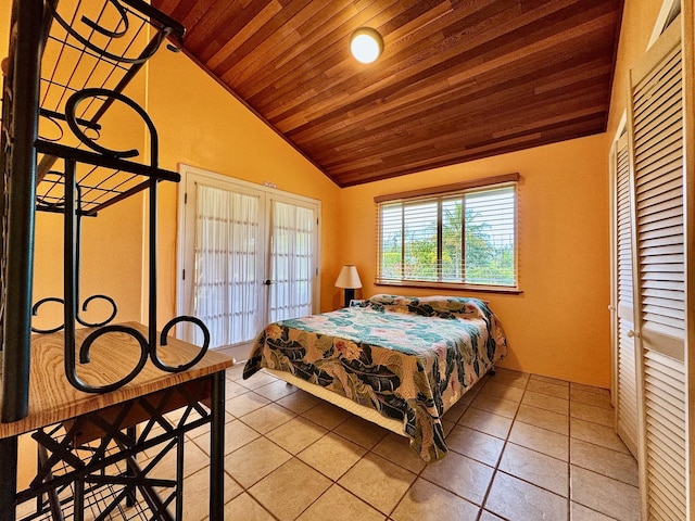 tiled bedroom featuring vaulted ceiling and a closet