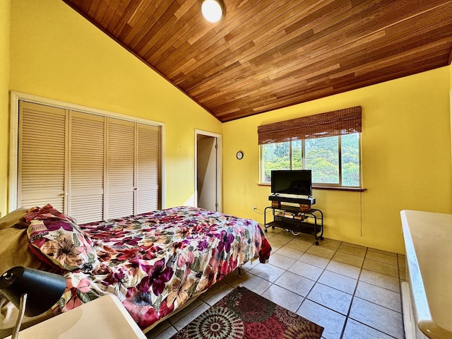 bedroom with lofted ceiling and light tile patterned floors