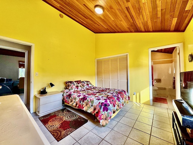 tiled bedroom with ensuite bathroom, vaulted ceiling, a closet, and wooden ceiling