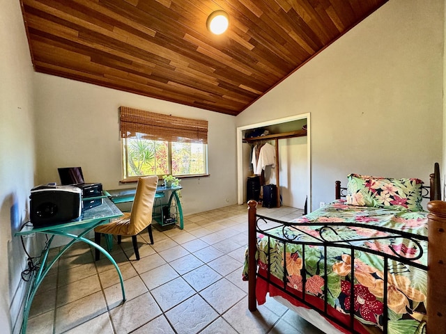 bedroom featuring light tile patterned flooring, wood ceiling, vaulted ceiling, and a closet