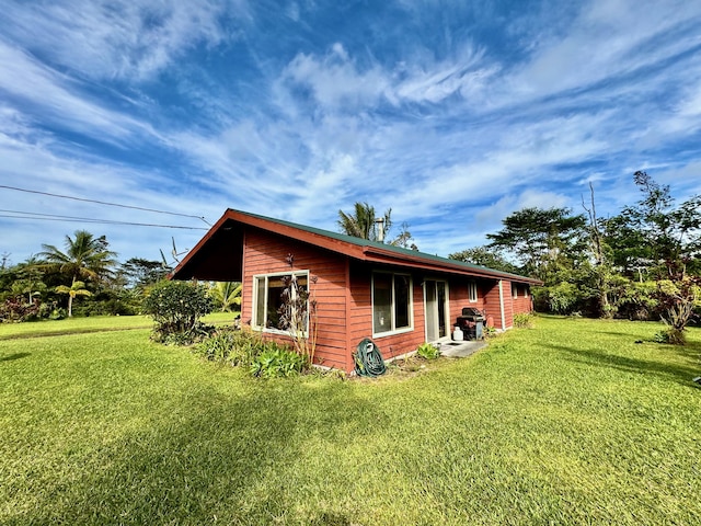 view of property exterior with a lawn