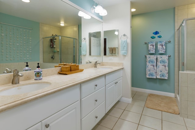 bathroom with vanity, an enclosed shower, and tile patterned flooring