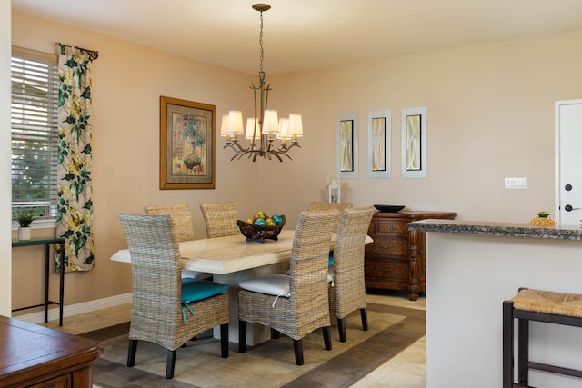 dining room featuring light tile patterned floors and a chandelier