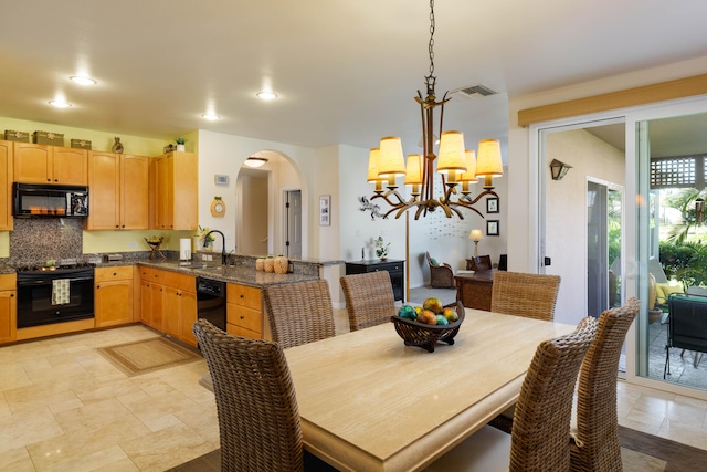 dining room featuring a chandelier and sink