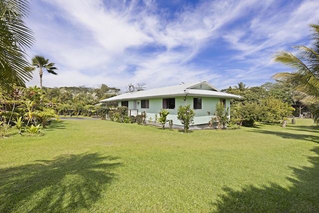 view of side of property featuring a yard