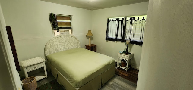 bedroom featuring wood finished floors and baseboards