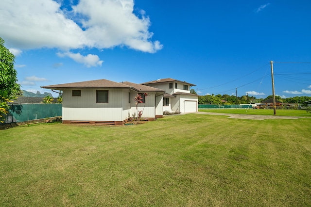 view of front of home with a garage and a front lawn