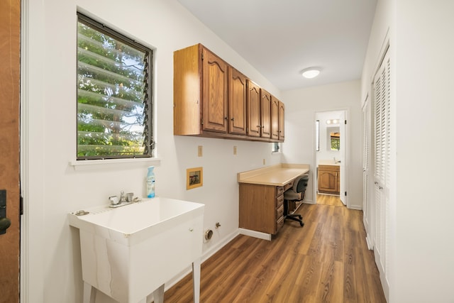 washroom featuring sink, cabinets, dark hardwood / wood-style flooring, hookup for a washing machine, and hookup for a gas dryer